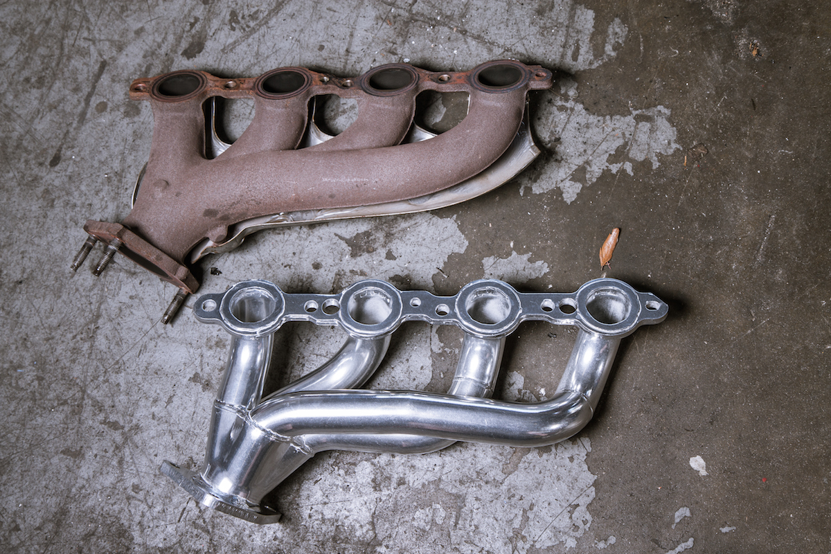 A side-by-side comparison shows the difference between the OEM exhaust manifold and the JBA shorty header. You can see that despite their similar size, the additional flow of the header primaries will help with our goals of increased performance.